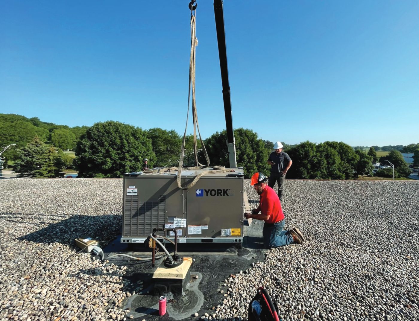 Rabine technicians setting a York rooftop unit
